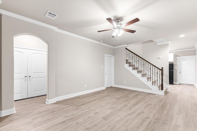 7970 Fowlie St, Houston, TX 77028 - unfurnished living room with light wood-style floors, crown molding, ceiling fan, arched walkways, and stairway