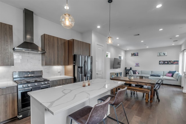 413 N Nagle St Unit B, Houston, TX 77003 - kitchen featuring appliances with stainless steel finishes, wall chimney exhaust hood, modern cabinets, dark wood-style flooring, and recessed lighting