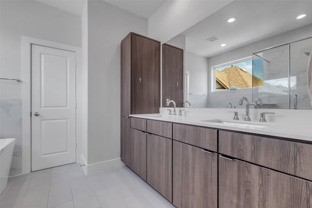 413 N Nagle St Unit B, Houston, TX 77003 - full bath with a freestanding bath, double vanity, tile patterned floors, a shower stall, and recessed lighting