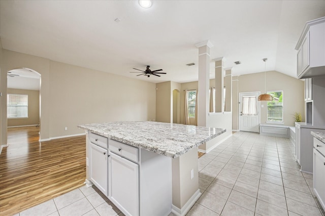 2708 Courtyard Ln, Pearland, TX 77584 - kitchen featuring arched walkways, light tile patterned flooring, ceiling fan, and healthy amount of natural light