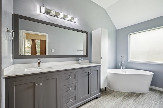 2708 Courtyard Ln, Pearland, TX 77584 - bathroom with lofted ceiling, double vanity, and a freestanding bath