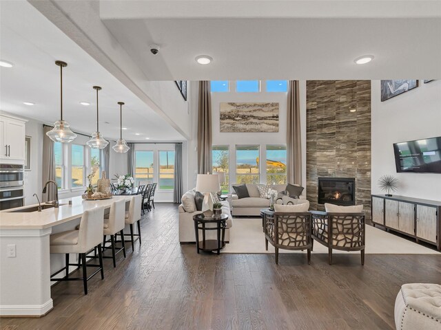 1588 River Point Dr, Friendswood, TX 77546 - living room with dark wood finished floors, a fireplace, and recessed lighting