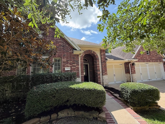 19011 Royal Cove Cir, Cypress, TX 77433 - traditional-style home featuring brick siding, roof with shingles, and a garage