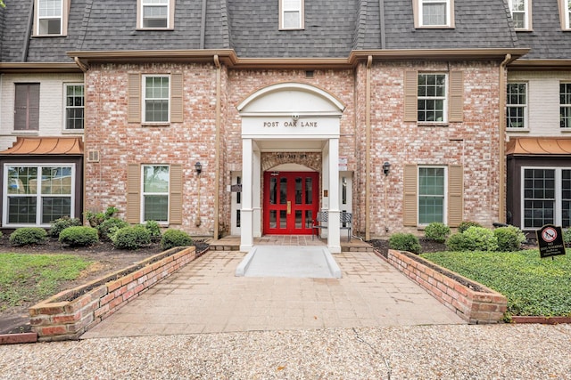 355 N Post Oak Ln Unit 839, Houston, TX 77024 - entrance to property featuring mansard roof, french doors, roof with shingles, and brick siding