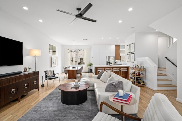1801 Oneil St Unit C, Houston, TX 77019 - living area with light wood finished floors, recessed lighting, a ceiling fan, stairs, and a chandelier