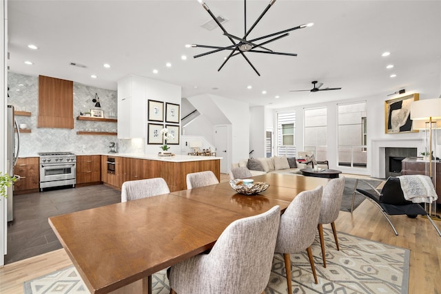 1801 Oneil St Unit C, Houston, TX 77019 - dining room featuring recessed lighting, a fireplace, light wood finished floors, and ceiling fan