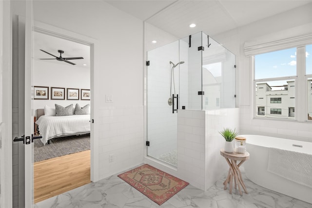 1801 Oneil St Unit C, Houston, TX 77019 - full bathroom with ensuite bathroom, marble look tiles, a stall shower, a soaking tub, and a ceiling fan
