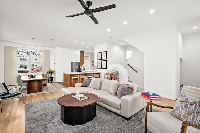 1801 Oneil St Unit C, Houston, TX 77019 - living room with light wood finished floors, stairs, recessed lighting, ceiling fan, and a chandelier