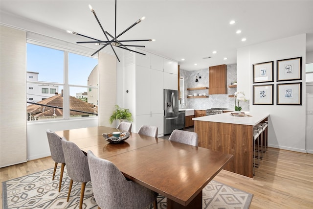 1801 Oneil St Unit C, Houston, TX 77019 - dining room featuring light wood finished floors, recessed lighting, and a chandelier