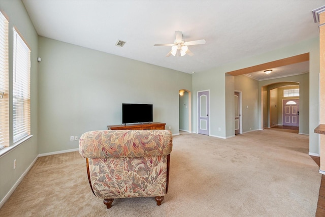 10207 Olive Mount St, Pearland, TX 77584 - living area featuring arched walkways, light colored carpet, and ceiling fan