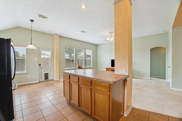 10207 Olive Mount St, Pearland, TX 77584 - kitchen featuring freestanding refrigerator, healthy amount of natural light, ceiling fan, arched walkways, and vaulted ceiling