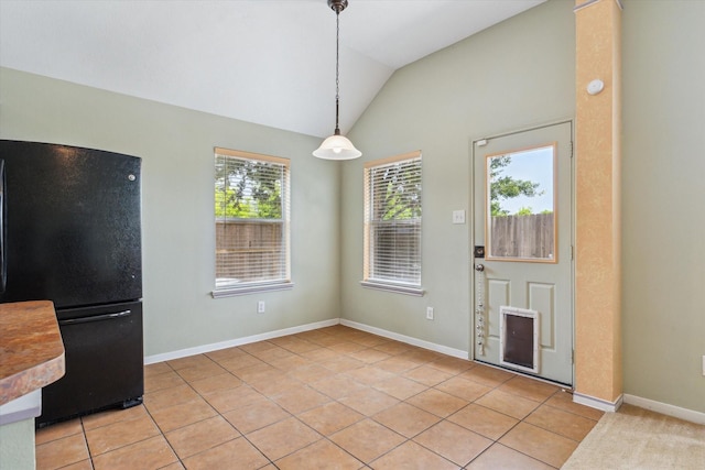 10207 Olive Mount St, Pearland, TX 77584 - unfurnished dining area with vaulted ceiling and light tile patterned floors