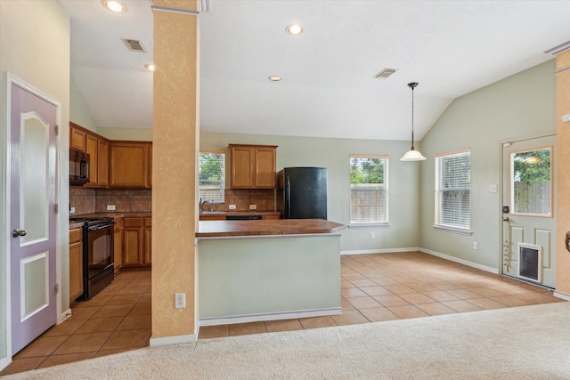 10207 Olive Mount St, Pearland, TX 77584 - kitchen featuring black appliances, vaulted ceiling, light tile patterned flooring, decorative backsplash, and hanging light fixtures