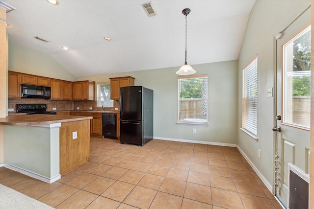 10207 Olive Mount St, Pearland, TX 77584 - kitchen featuring black appliances, vaulted ceiling, tasteful backsplash, light tile patterned floors, and brown cabinets