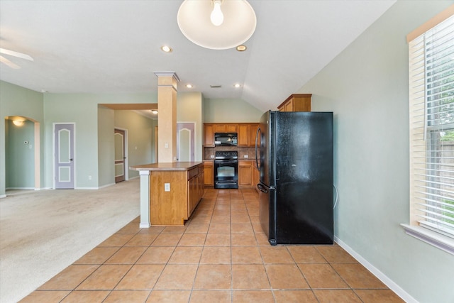 10207 Olive Mount St, Pearland, TX 77584 - kitchen with black appliances, brown cabinetry, open floor plan, healthy amount of natural light, and vaulted ceiling