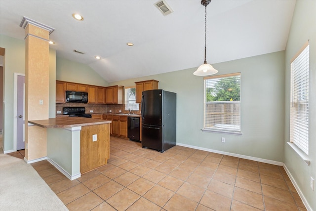 10207 Olive Mount St, Pearland, TX 77584 - kitchen featuring black appliances, lofted ceiling, brown cabinets, hanging light fixtures, and tasteful backsplash