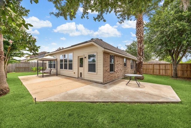 10207 Olive Mount St, Pearland, TX 77584 - back of house with a patio, a fenced backyard, and brick siding