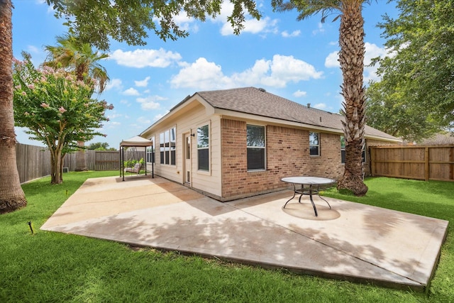 10207 Olive Mount St, Pearland, TX 77584 - rear view of house with brick siding, a patio area, a fenced backyard, and roof with shingles