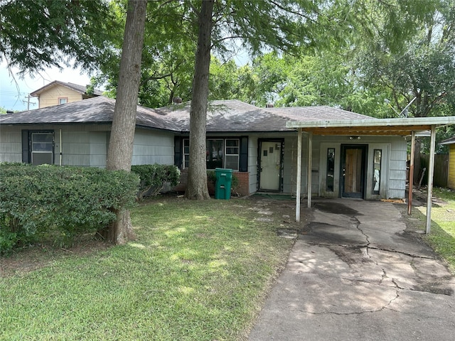 1904 Lillian St, Pasadena, TX 77502 - view of front of house with a front lawn, driveway, a carport, and a shingled roof