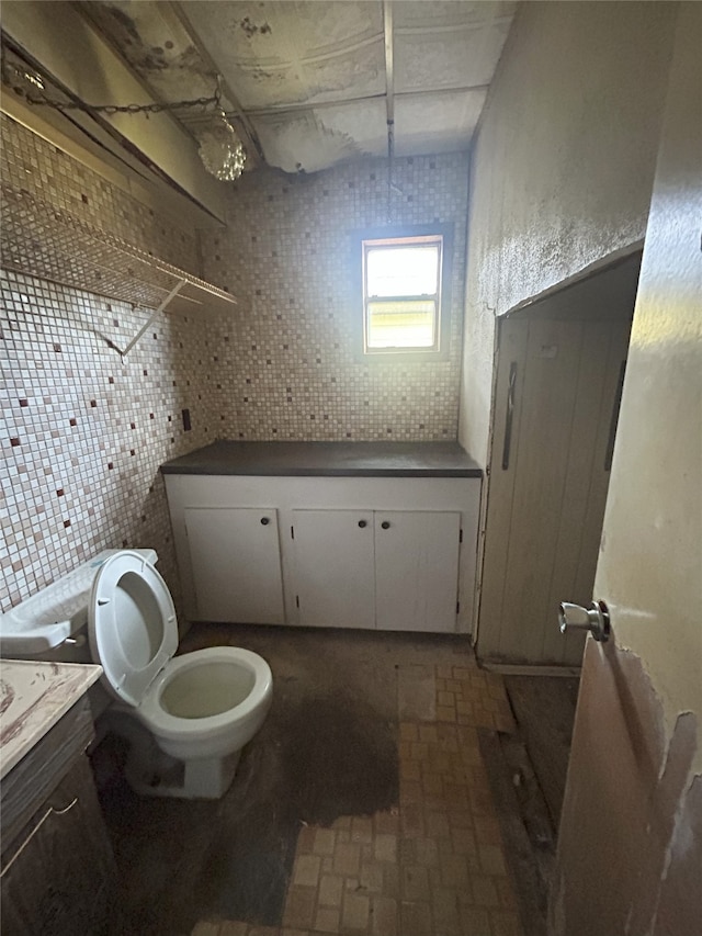 1904 Lillian St, Pasadena, TX 77502 - half bath with vanity, brick patterned flooring, and tile walls