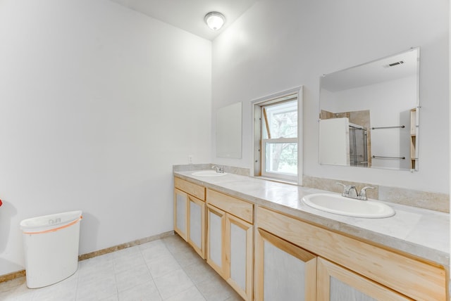 131 Canary Ln, Coldspring, TX 77331 - bathroom featuring a stall shower, double vanity, and tile patterned flooring