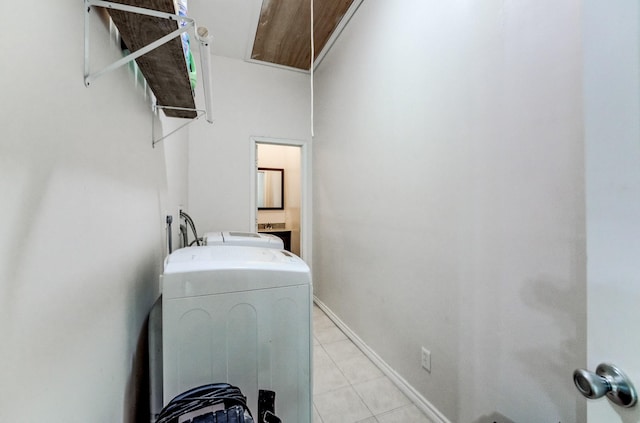 131 Canary Ln, Coldspring, TX 77331 - laundry area featuring washer / dryer, attic access, and light tile patterned floors