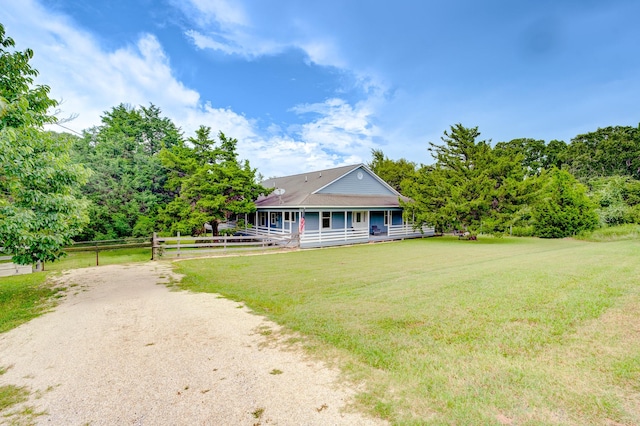 131 Canary Ln, Coldspring, TX 77331 - farmhouse featuring a porch and driveway