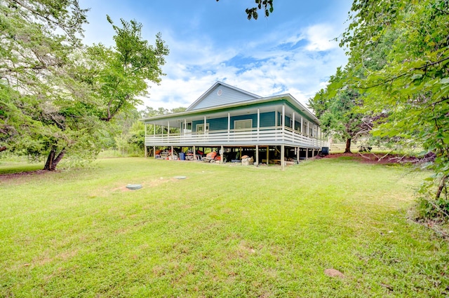 131 Canary Ln, Coldspring, TX 77331 - back of house featuring a yard and a sunroom