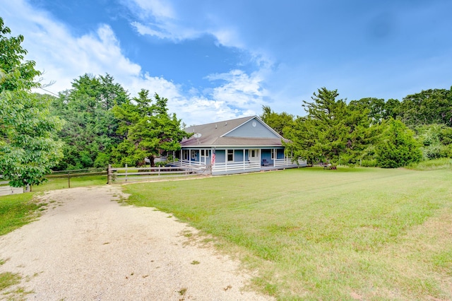131 Canary Ln, Coldspring, TX 77331 - farmhouse inspired home featuring covered porch and dirt driveway
