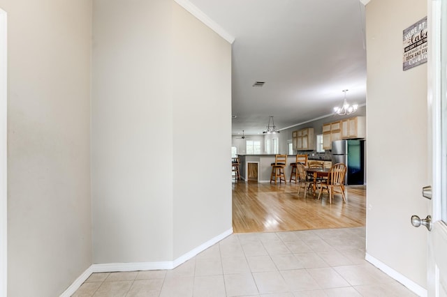 131 Canary Ln, Coldspring, TX 77331 - corridor featuring a chandelier, ornamental molding, and light tile patterned floors