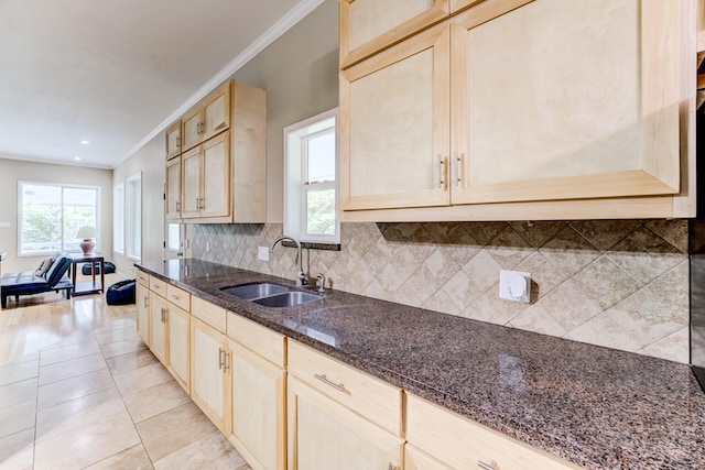 131 Canary Ln, Coldspring, TX 77331 - kitchen featuring crown molding, dark stone counters, light brown cabinets, tasteful backsplash, and light tile patterned floors