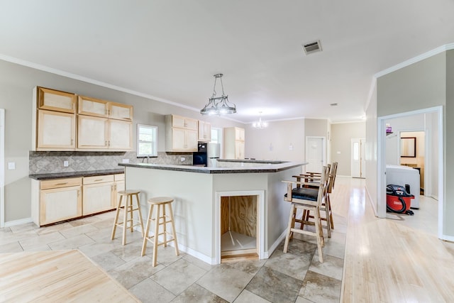 131 Canary Ln, Coldspring, TX 77331 - kitchen with refrigerator, ornamental molding, light brown cabinets, a breakfast bar, and decorative backsplash