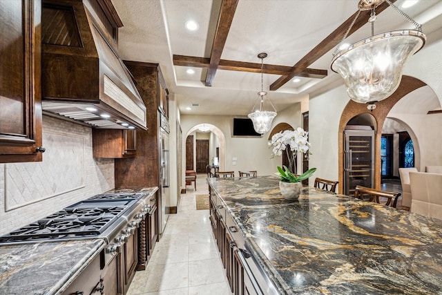 3751 Aberdeen Way, Houston, TX 77025 - kitchen featuring arched walkways, stainless steel gas stovetop, custom exhaust hood, coffered ceiling, and decorative backsplash