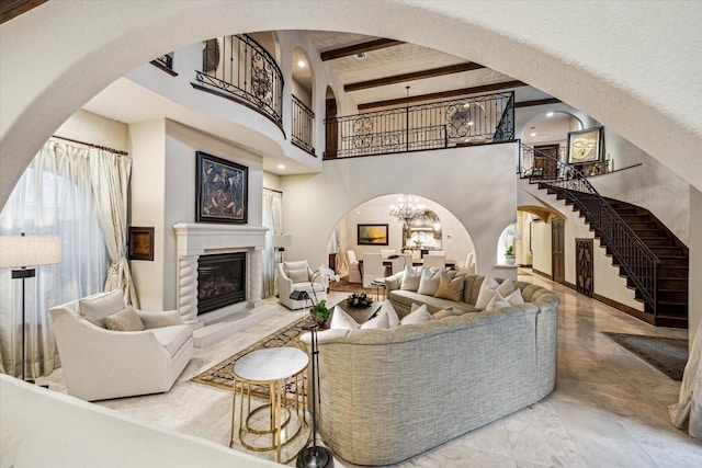 3751 Aberdeen Way, Houston, TX 77025 - living area with arched walkways, marble tiled floors, stairway, a towering ceiling, and a glass covered fireplace