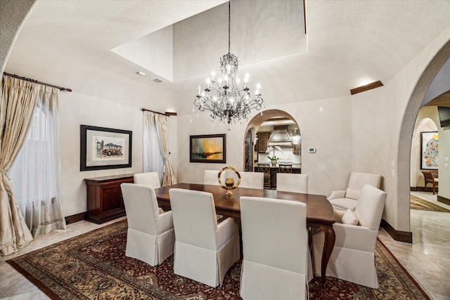 3751 Aberdeen Way, Houston, TX 77025 - dining space with arched walkways, marble tiled floors, and a chandelier