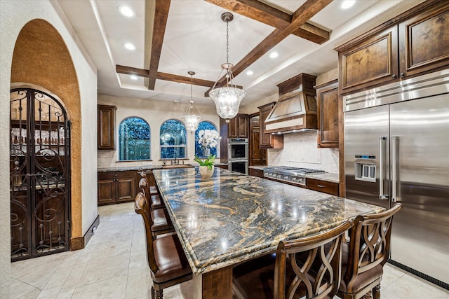 3751 Aberdeen Way, Houston, TX 77025 - kitchen with stainless steel appliances, coffered ceiling, arched walkways, backsplash, and custom range hood