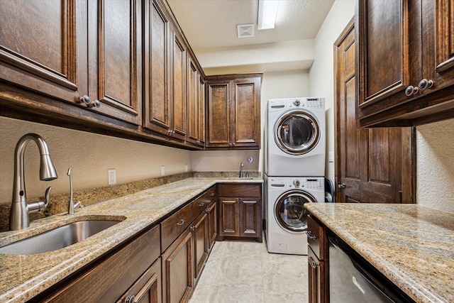 3751 Aberdeen Way, Houston, TX 77025 - washroom with stacked washing machine and dryer and cabinet space