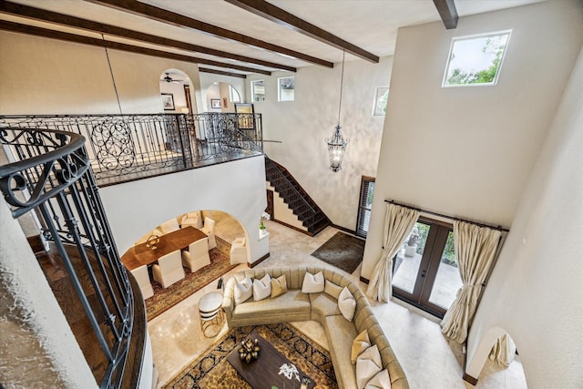 3751 Aberdeen Way, Houston, TX 77025 - living room with beamed ceiling, a chandelier, healthy amount of natural light, and french doors