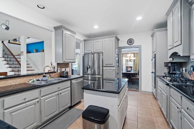 2326 Vinemead Ct, Katy, TX 77450 - kitchen with stainless steel appliances, gray cabinets, decorative backsplash, a kitchen island, and a chandelier