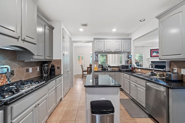 2326 Vinemead Ct, Katy, TX 77450 - kitchen featuring stainless steel appliances, a center island, gray cabinets, tasteful backsplash, and recessed lighting