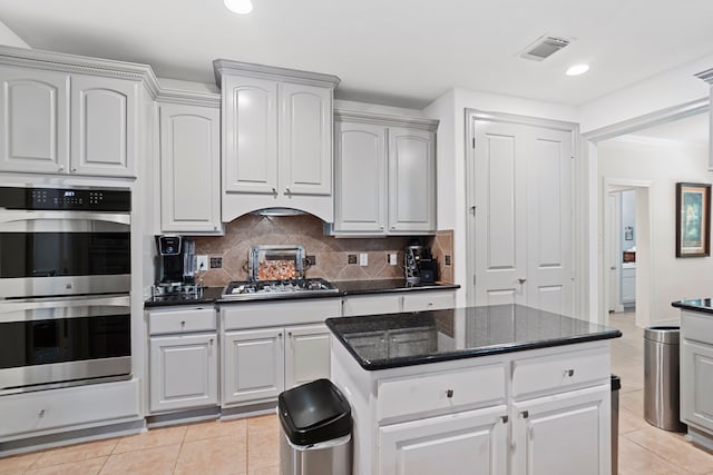 2326 Vinemead Ct, Katy, TX 77450 - kitchen with appliances with stainless steel finishes, decorative backsplash, light tile patterned flooring, recessed lighting, and dark stone countertops
