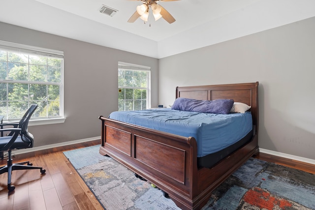 2326 Vinemead Ct, Katy, TX 77450 - bedroom with multiple windows, wood finished floors, an office area, and a ceiling fan