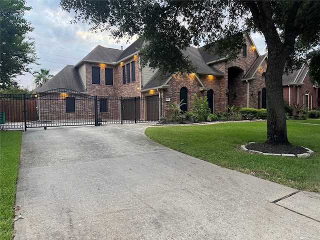 14410 Brentshire Ln, Houston, TX 77069 - view of front of home with brick siding, a gate, curved driveway, and a shingled roof