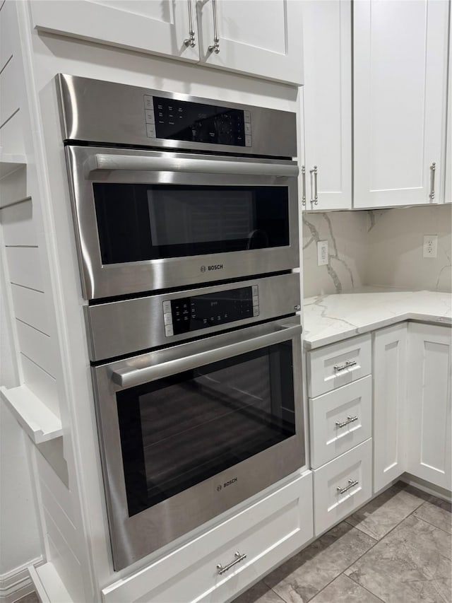 14410 Brentshire Ln, Houston, TX 77069 - kitchen featuring white cabinets, double oven, and light stone counters
