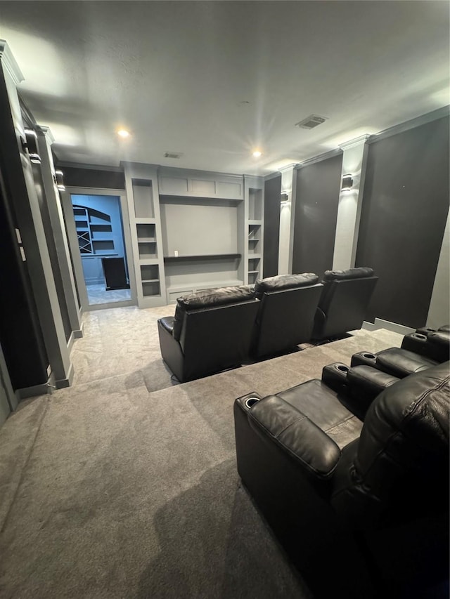 14410 Brentshire Ln, Houston, TX 77069 - home theater room featuring light colored carpet, crown molding, recessed lighting, and built in shelves