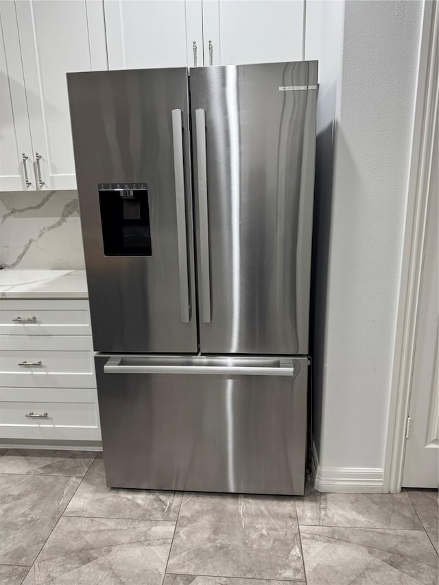 14410 Brentshire Ln, Houston, TX 77069 - kitchen view of stainless steel fridge with ice dispenser, white cabinetry, and light stone counters