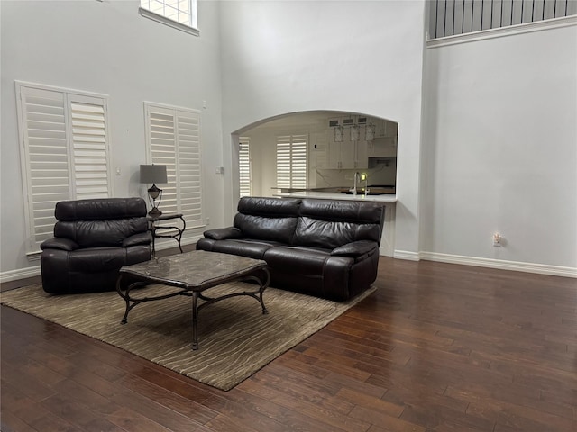 14410 Brentshire Ln, Houston, TX 77069 - living room with arched walkways, a high ceiling, hardwood / wood-style floors, and plenty of natural light