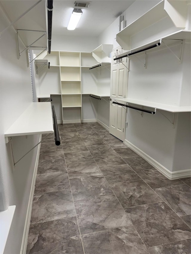 14410 Brentshire Ln, Houston, TX 77069 - walk in closet featuring dark marble finish flooring