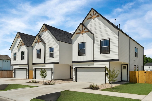 2206 Mansfield, Houston, TX 77091 - view of front of house with an attached garage, driveway, board and batten siding, and roof with shingles