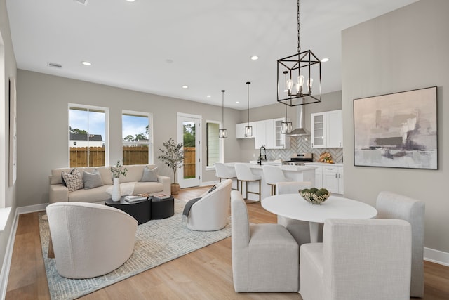 2206 Mansfield, Houston, TX 77091 - living area featuring light wood-style floors, recessed lighting, and a chandelier